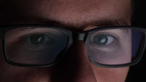 Close Up Of A Mans Eyes Reading Off Computer Screen Through Glasses. 動画素材 124733144