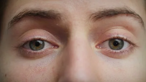 Close up of Man's face. Attractive boy with blue eyes raising eyebrows. Stock Footage 142908197