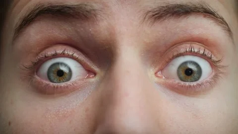 Close up of Man's face. Attractive boy opening his blue eyes in fear. Stock Footage 142908527