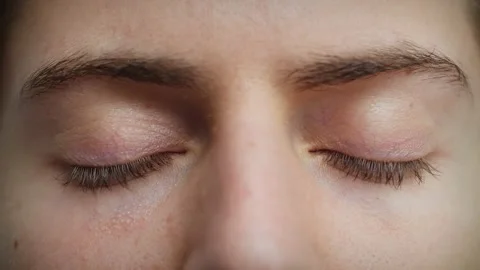 Close up of Man's face. Attractive boy closing his beautiful blue eyes. Stock Footage 142909462