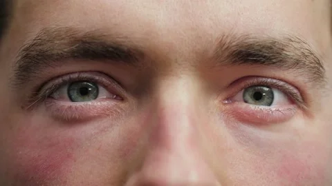 Close up of Man's face. Attractive boy opening his beautiful blue eyes. Vídeos de archivo 165206082