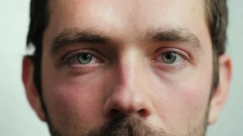 Close up of Man's face. Attractive boy opening and closing his beautiful eyes. Video stock 165207966