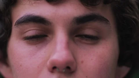 Close up of Man's face. Attractive boy opening his beautiful blue eyes Stock Footage 243842291