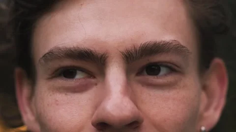 Close up of Man's face. Attractive young man smiling with his beautiful eyes Stock Footage 242951236