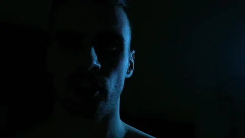 Close-up of a man's face backlit blue Stock Footage 153236003