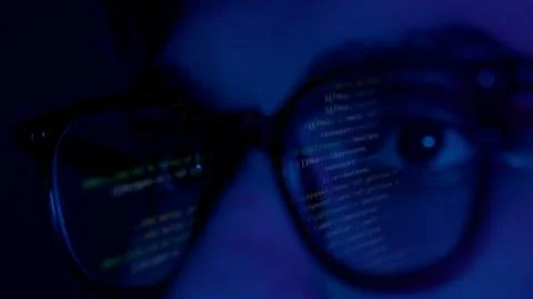 Close up of man's face with binary code reflection on glasses Stock Photos