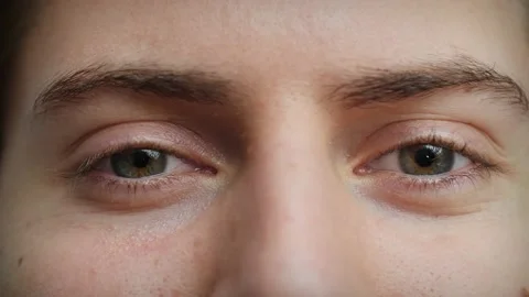 Close up of Man's face. Boy with blue eyes looking at camera with wink. Stock Footage 142908222