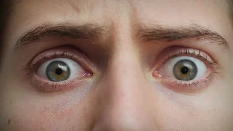 Close up of Man's face . Boy opening blue eyes wide looking around. Stock Footage 142908416