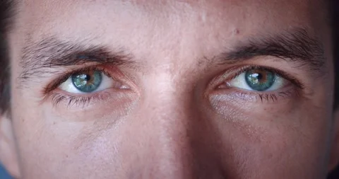 Close up of Man's face. Caucasian young man with blue eyes looking at camera Stock Footage 231949073