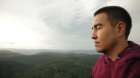 Close-up of man's face with closed eyes. A man enjoys being alone. Stock Footage 91045249