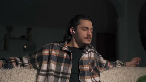 Close-up of a man's face dancing to music playing with headphones Видео 170605040