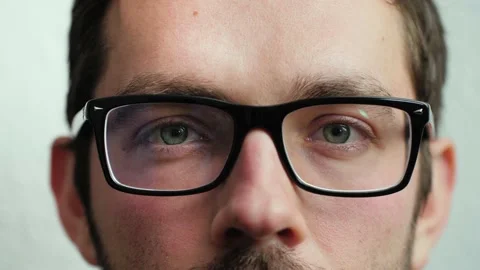 Close up of man's face with glasses. Boy opening and closing his beautiful eyes. Stock Footage 165207873
