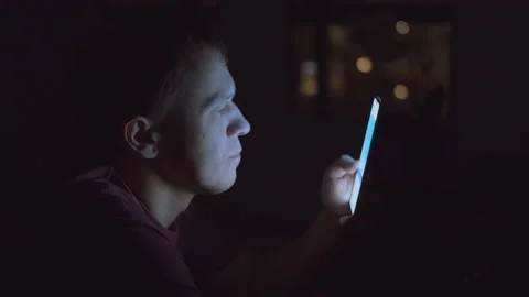 Close up man's face, light from mobile phone screen, man browsing mobile Stock Footage 156299113
