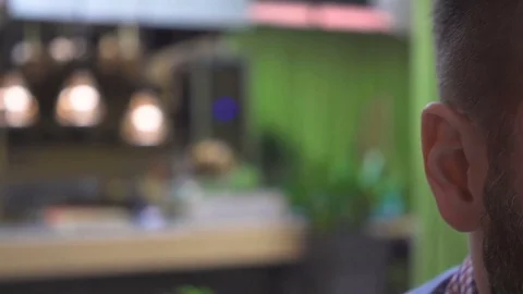 Close up of man's face, look at camera, portrait, pub cafe, very close steadicam 库存影片 73067348