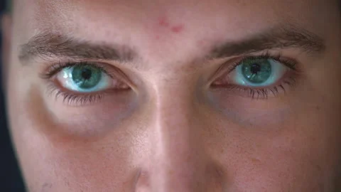 Close up of Man's face raising eyebrow. Boy with blue eyes looking at camera Stock Footage 170978360