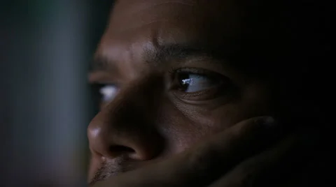 Close up on a man's face watching a screen at night in the dark Видео 68086700