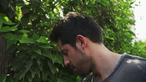 Close-up of a man's face while cooking on a grill in a country house among trees Vidéo 170017609