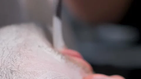 Close-up of a man's face while putting a medical mask on the man's face Stock-Footage 250356599