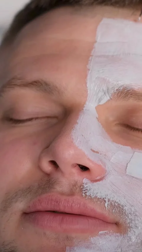 Close-up of a man's face while putting a mask on a man's face. Men's skin care Stock-Footage 250382384