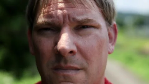 Close up of a man's face while walking outdoors in hot weather Stock Footage 247314797