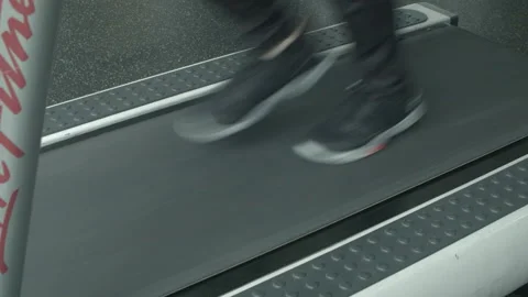 Close Up of a Man's Feet Running on a Treadmill Stock Footage 233853910