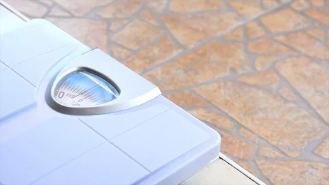 Close up man's feet standing on body weight scales for measure weight Stock Footage 113003125