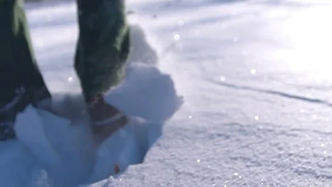 Close-up of man's feet walking on the mountains in the snow. Slow-motion filming Stock Footage 70809095
