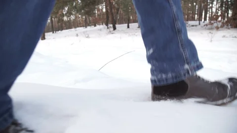 Close-up of man's feet walking on the mountains in the snow. Slow-motion filming Stock Footage 101694068