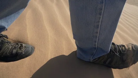 Close up of a man's feet while hiking on sand dunes Stock Footage 87502540