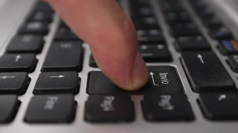 Close-up, man's finger presses the enter key on the notebook keyboard Stock Footage 144340730