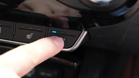 A close-up of a man's finger pressing button for air-conditioned car seats. Stock Footage 342086288