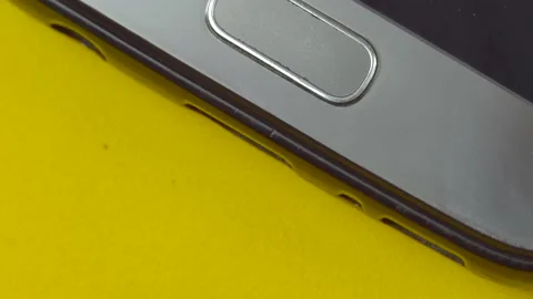 Close-up of a man's fingers connects the cable to the smartphone Stock Footage 136488169