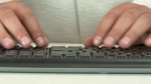 Close-up of a man's fingers typing on a computer keyboard Video stock 345750096