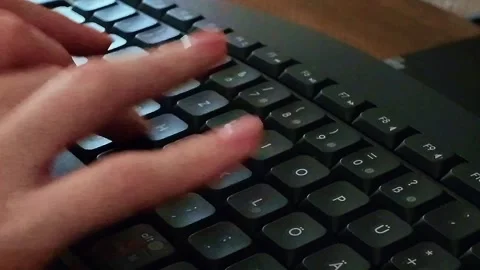 Close-up of mans fingers typing on laptop keyboard in modern café Stock Footage 337257281