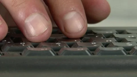 Close-up of a man's fingers typing on a modern computer keyboard Video stock 345750084