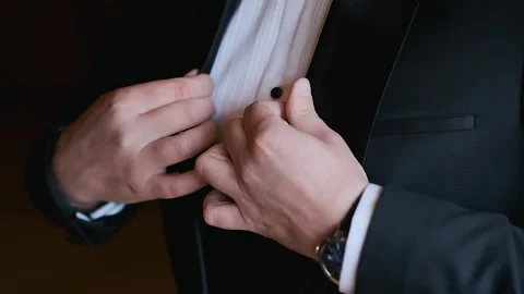 Close-up of a man's hand adjusting his jacket Stock Footage 196117083