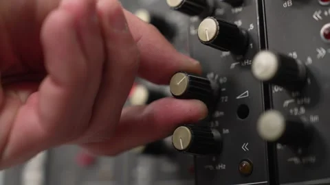 Close up of man's hand adjusting knob of retro audio mixer. Stock Footage 331923926