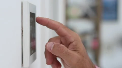 Close-up of man's hand adjusting the temperature on a home automation screen. Stock Footage 220033227