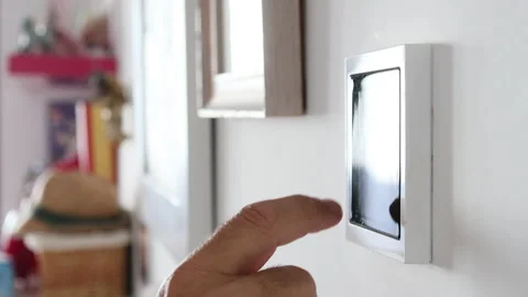 Close-up of man's hand adjusting the temperature on a home automation screen Stock Footage 223534680