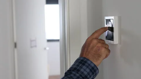 Close-up of man's hand adjusting the temperature on a home automation screen. Stock Footage 224884001