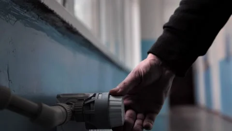 Close-up of man's hand adjusts the temperature of the battery Stock Footage 222966891