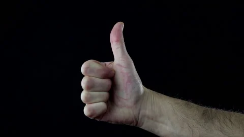 Close up, man's hand on black background making the thumb up sign. Stock Footage 144208427