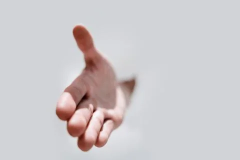 Close up.a man's hand breaking through the paper wall Stock Photos