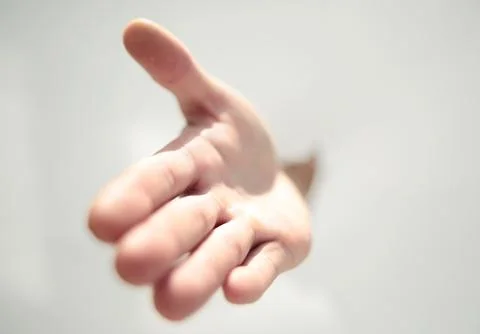 Close up.a man's hand breaking through the paper wall Stock Photos