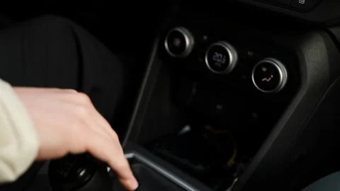 Close up of a man's hand changing gear with stick shift in modern vehicle. Stock Footage 339580733