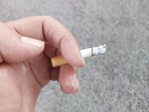 Close up of mans hand with cigarette. Stock Photos