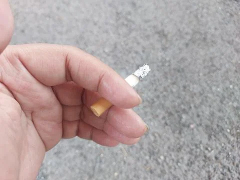 Close up of mans hand with cigarette. Stock Photos