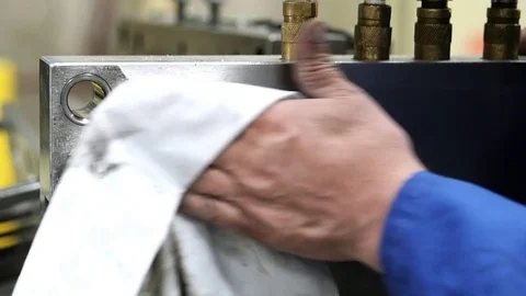 Close-Up Of Man's Hand Cleaning A Metal Mold Stock Footage 78564473