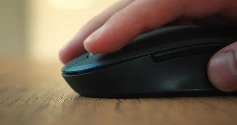 Close-up man's hand click a computer mouse and uses a roller while working at Stock-Footage 225887175