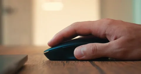 Close-up man's hand clicks a computer mouse and uses a roller while working at Stock Footage 225886629